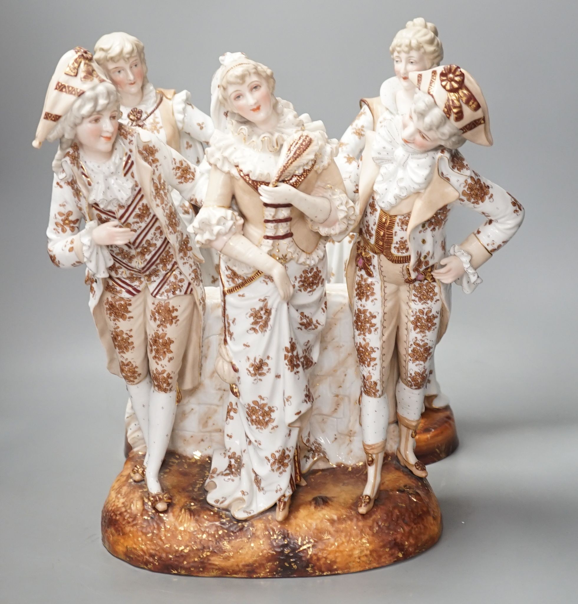 A pair of large French porcelain figures, 38cm, and a figural group en suite